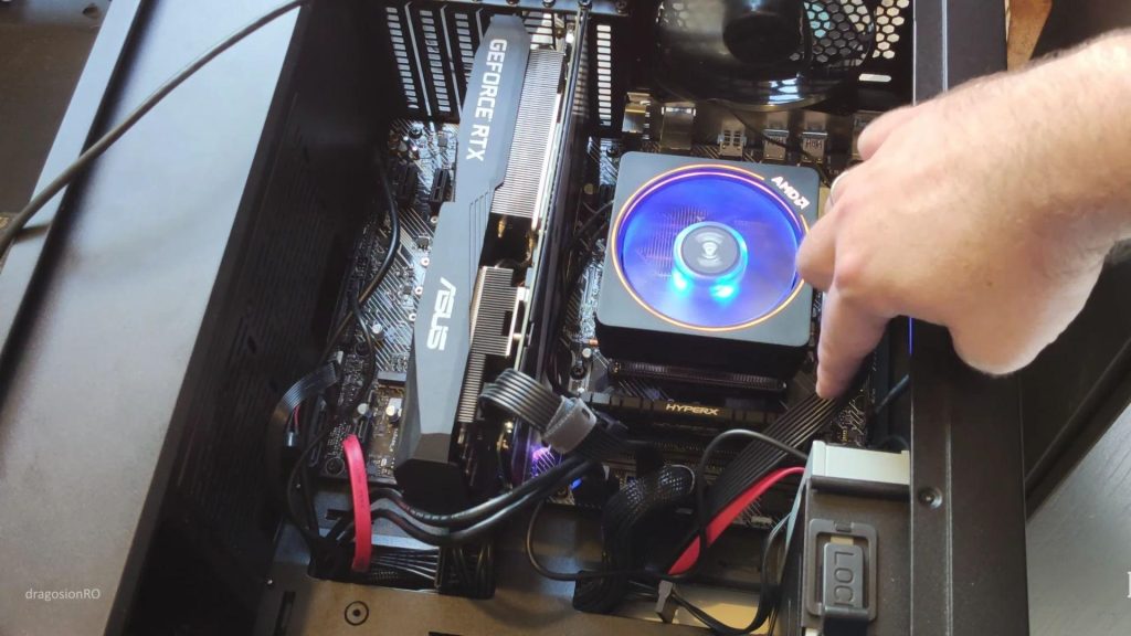 A gamer assembling a custom gaming PC with RGB components and modern hardware parts.