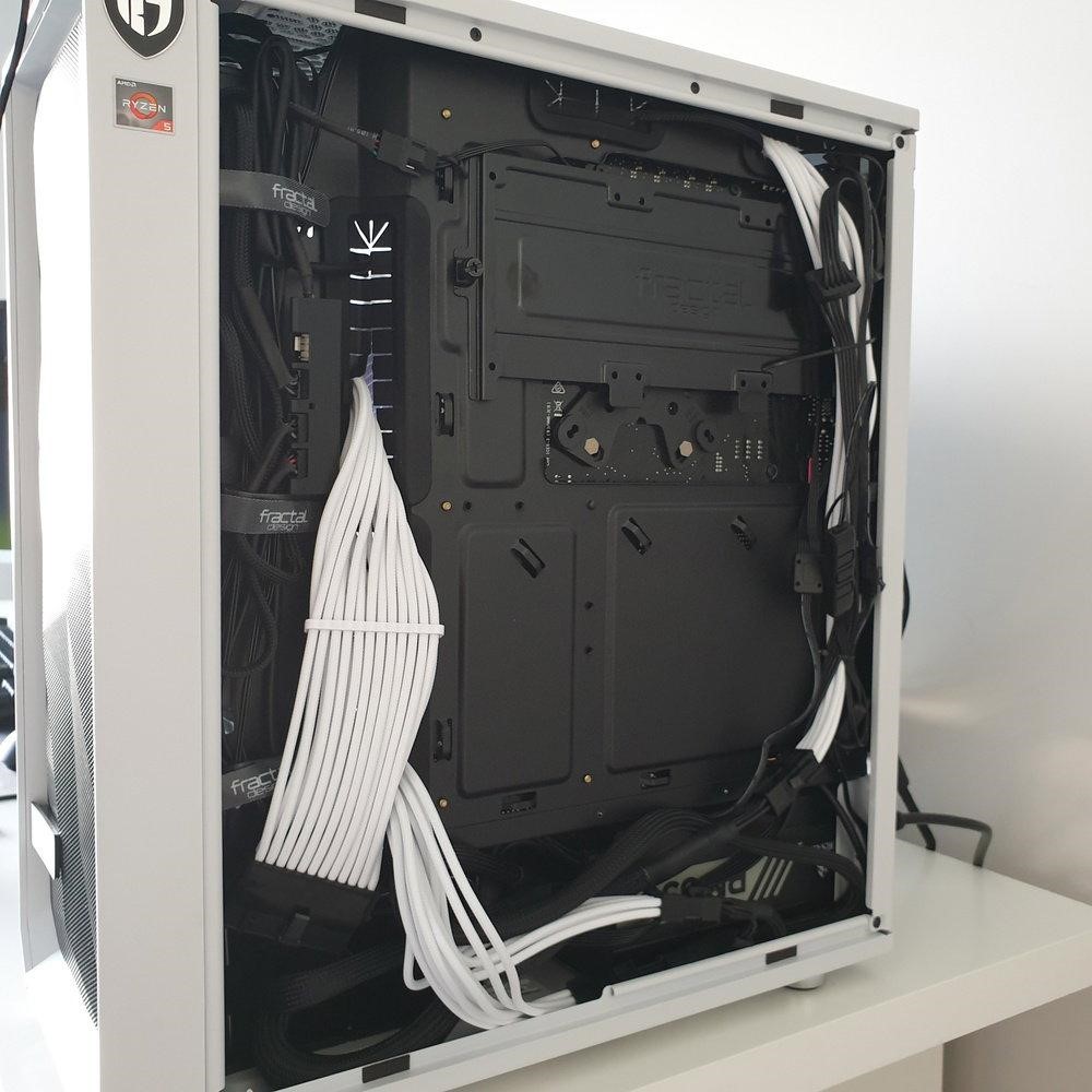 Desktop computer interior showing professional cable management with neatly routed cables and visible hardware components