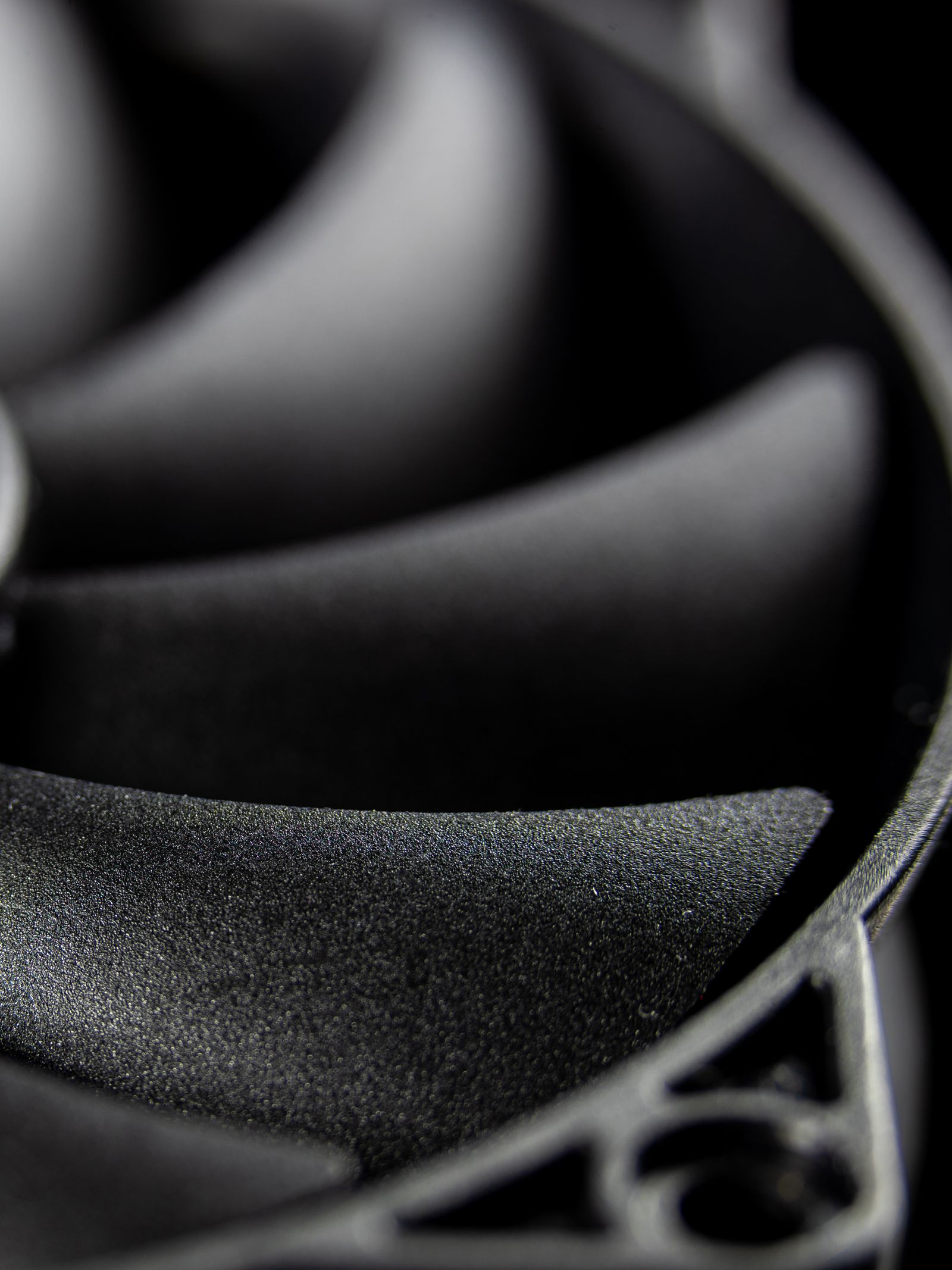 Detailed macro shot of a computer cooling fan in grayscale