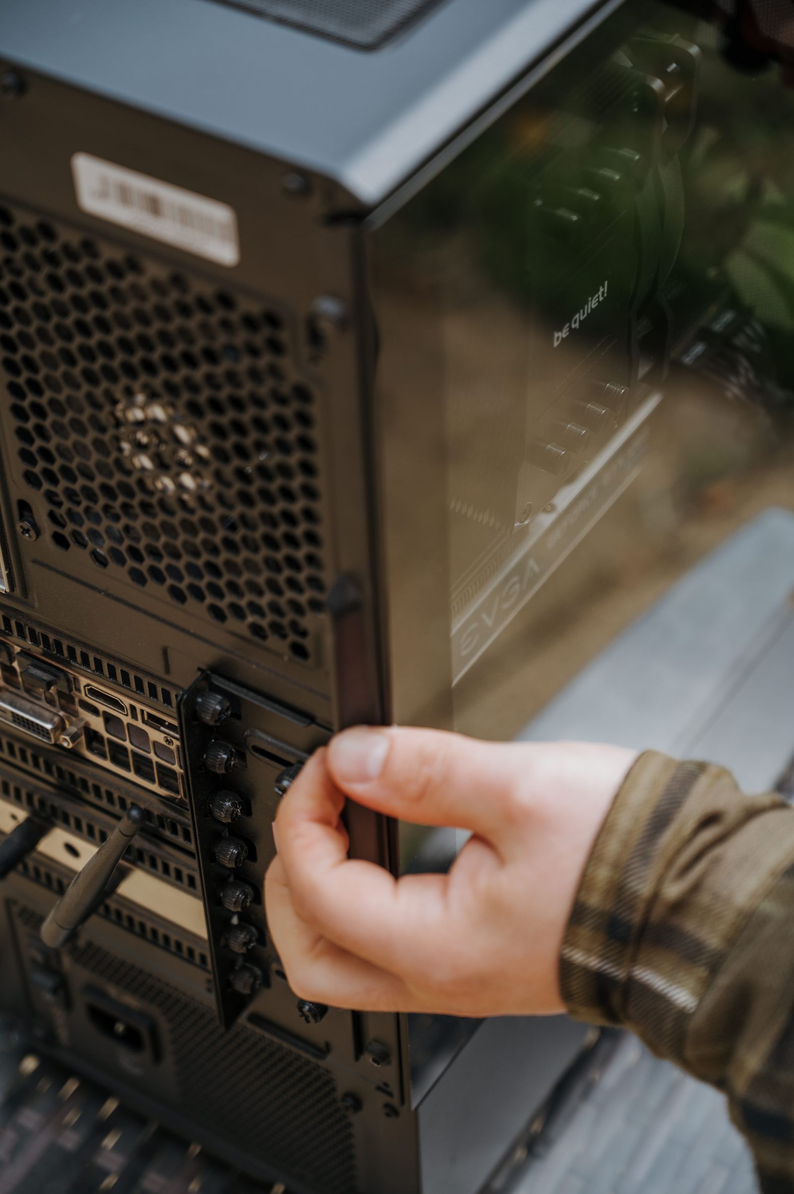 Hands cleaning and maintaining desktop computer hardware