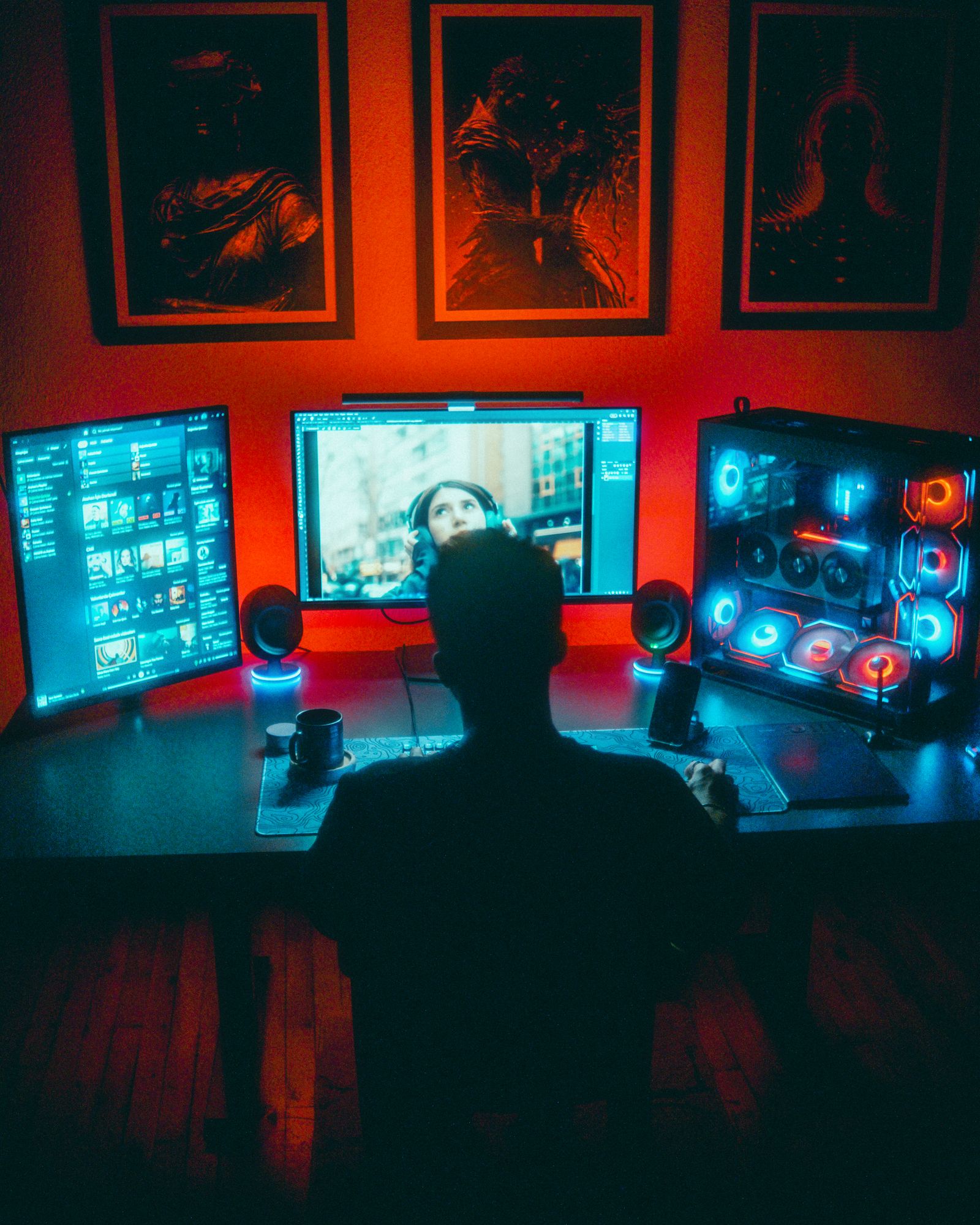 Gamer immersed in RGB PC setup with dual monitors at night