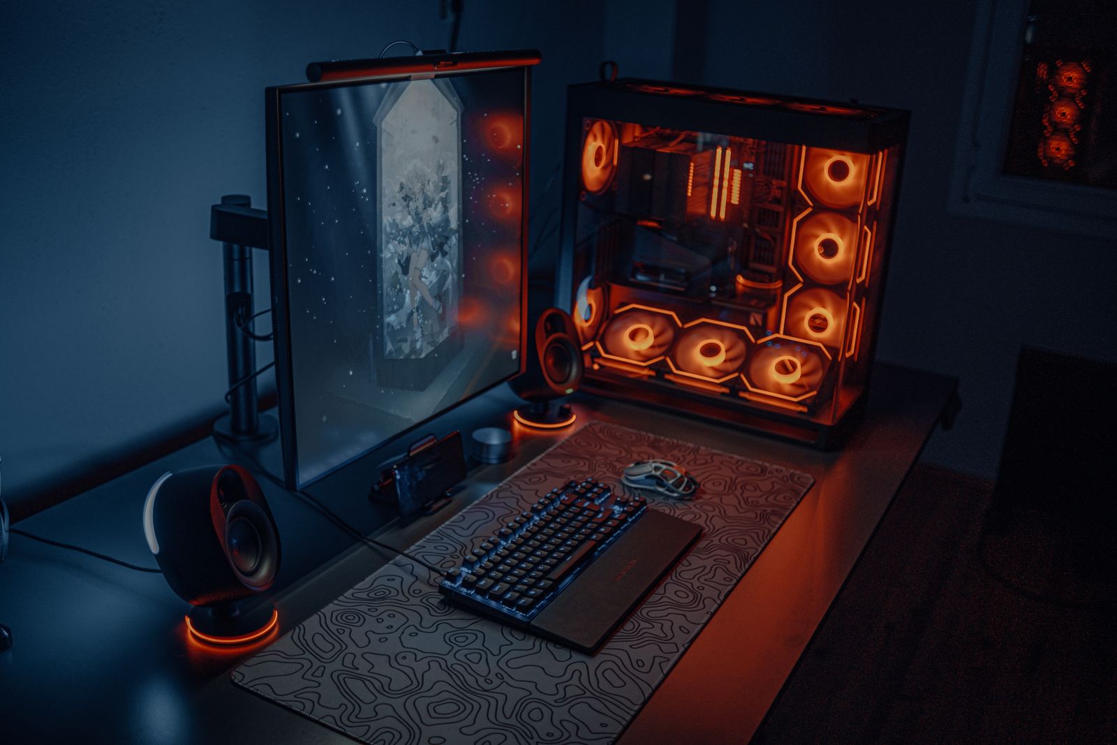 Modern gaming desk setup with RGB lighting, monitor, and PC
